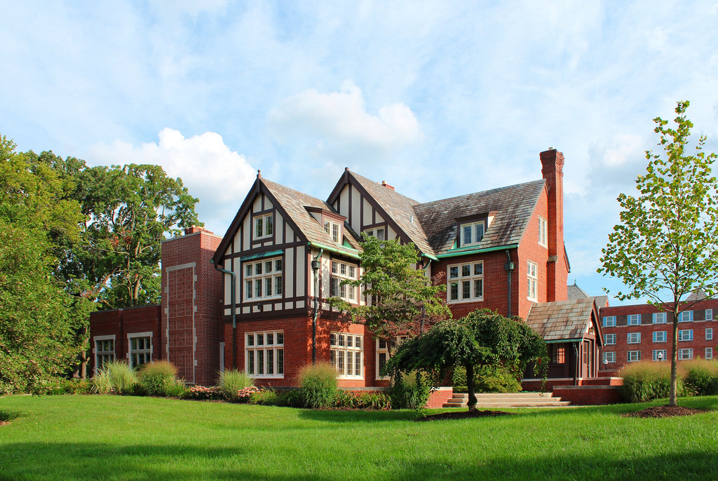 Kuhn Honors and Scholars surrounded by a lush green lawn and several trees