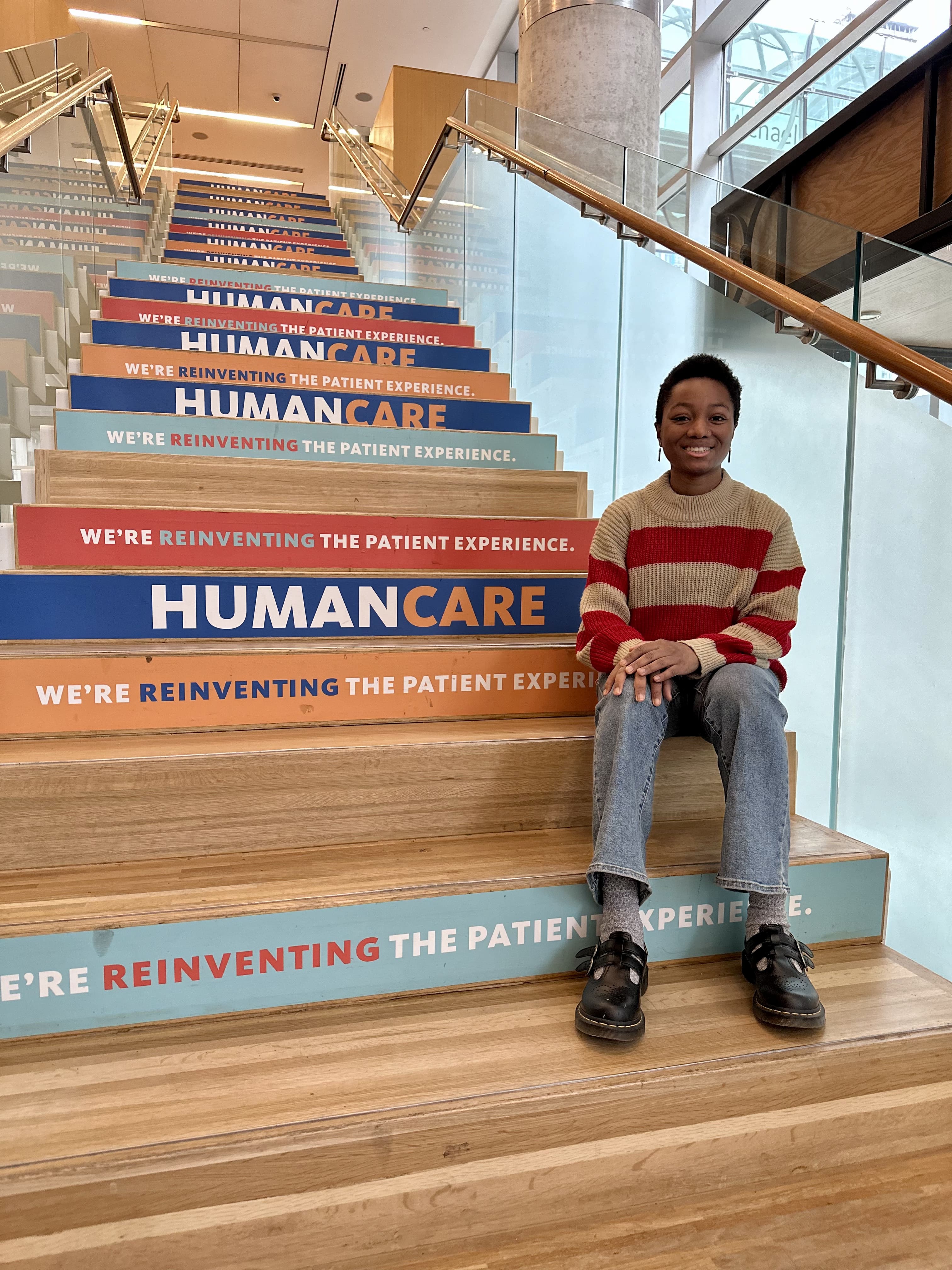 Individual sitting on the steps at St. Michael’s Hospital Li Ka Shing Knowledge Institute